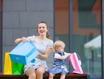 Mother and kid examines purchases after shopping