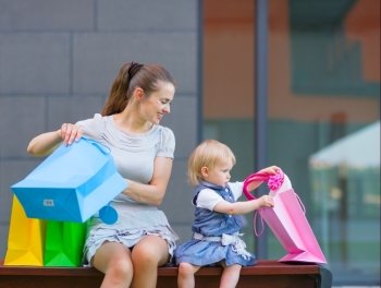 Mother and baby looking into shopping bag