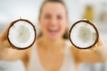Closeup on young woman showing coconut pieces