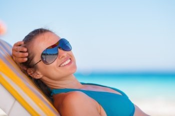 Smiling woman laying on beach