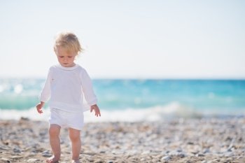 Baby walking on beach