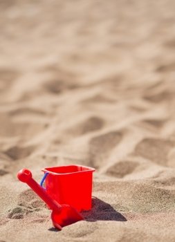 Baby bucket and shovel on the sandy beach
