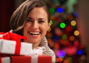 Happy young woman holding Christmas gift boxes