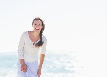 Portrait of smiling young woman on sea shore