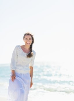 Portrait of smiling young woman at seaside