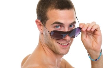 Portrait of happy young man looking out from sunglasses