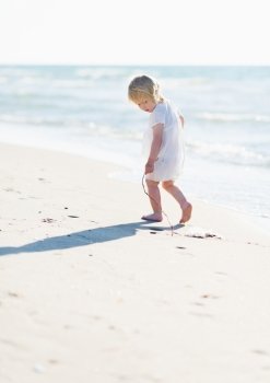 Lonely baby playing on sea shore