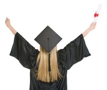 Woman in graduation gown rejoicing success . rear view