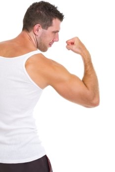 Athletic man showing strong biceps