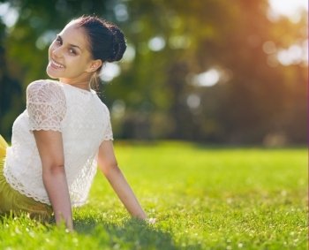 Portrait of happy girl sitting on meadow