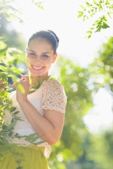 Smiling girl playing in foliage
