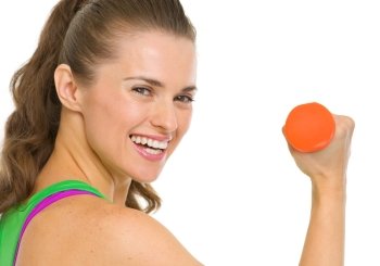 Portrait of smiling fitness young woman with dumbbell