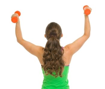 Fitness woman with dumbbells rejoicing success