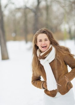 Portrait of happy young woman in winter park