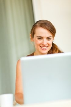 Portrait of beautiful woman working on laptop
