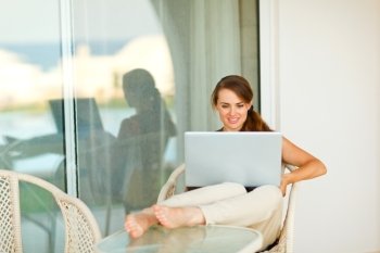 Portrait of beautiful woman working on laptop on terrace
