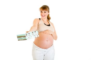 Smiling pregnant woman touching her belly and  holding present for baby  isolated on white
