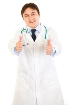 Smiling medical doctor showing thumbs up gesture  isolated on white
