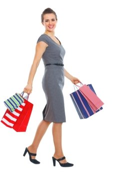Full length portrait of happy woman with shopping bags