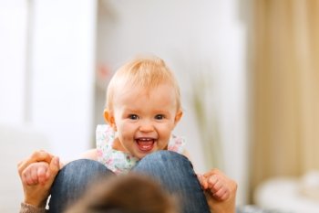 Portrait of smiling playing baby at home
