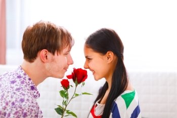 Young man presenting a flower to his girlfriend
