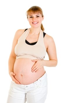 Smiling beautiful pregnant female holding her belly isolated on white background
