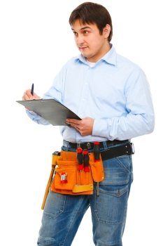 Construction worker checking something and writing in clipboard
