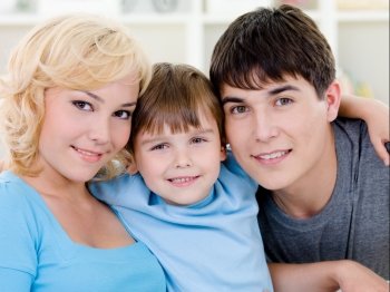 Close-up portrait of happy smiling cheerful family with son - indoors