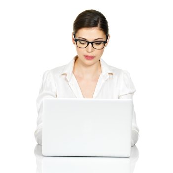 Woman with  laptop  in white shirt sits from the table - isolated on white. 
