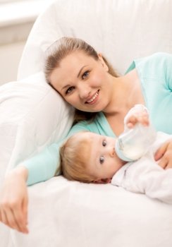 happy mother and adorable baby with feeding-bottle