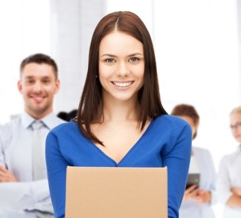 business and delivery service concept - smiling woman holding cardboard box