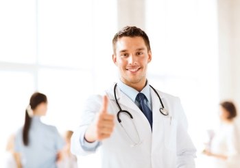 healthcare and medical concept - doctor with stethoscope showing thumbs up