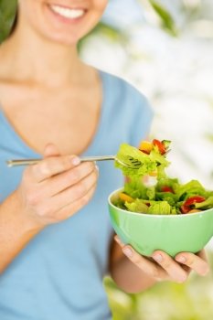 healthy food and dieting concept - woman eating salad with vegetables