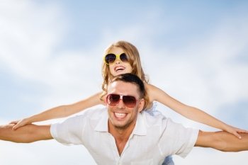 summer holidays, children and people concept - happy father and child in sunglasses over blue sky