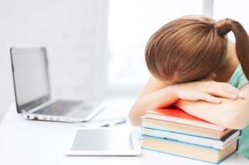 business, office, school and education concept - tired student sleeping on stock of books
