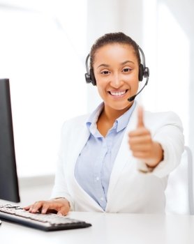 business, office and communication concept - african female helpline operator with headphones showing thumbs up