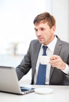 technology, business and office concept - handsome businessman working with laptop computer
