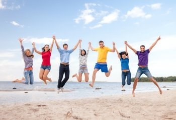 summer, holidays, vacation, happy people concept - group of friends jumping on the beach