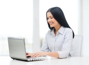 education, business and technology concept - smiling businesswoman or student with laptop computer