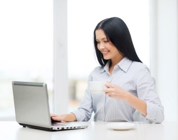 education, business and technology concept - smiling businesswoman or student with laptop computer and coffee
