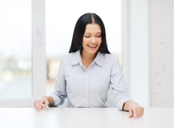 business, education and technology concept - smiling woman pointing to something or pressing imaginary button