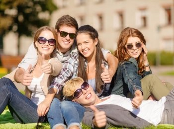summer holidays, education, campus and teenage concept - group of students or teenagers showing thumbs up