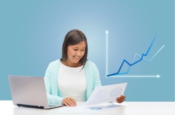 business and technology concept - asian businesswoman or student with laptop, documents and graph in office