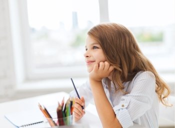 education, creation and school concept - smiling little student girl drawing and daydreaming at school