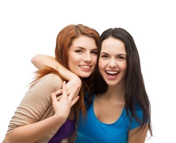 friendship and happy people concept - two laughing girls hugging