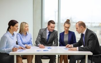 business and office concept - business team with documents having discussion in office