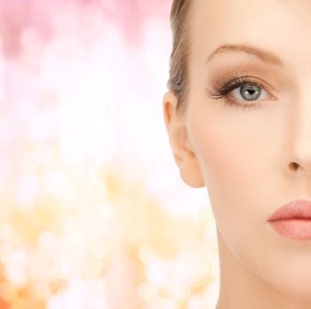 health, beauty and spa concept - close up of face of beautiful young woman