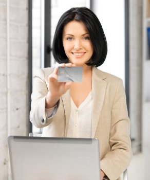 picture of happy woman with laptop computer and credit card.