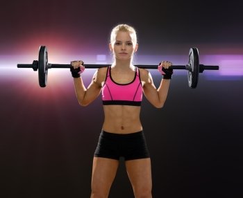 fitness, sport and dieting concept - sporty woman exercising with barbell