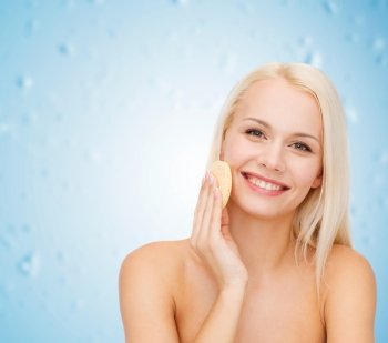 health, beauty and spa concept - beautiful woman with sponge